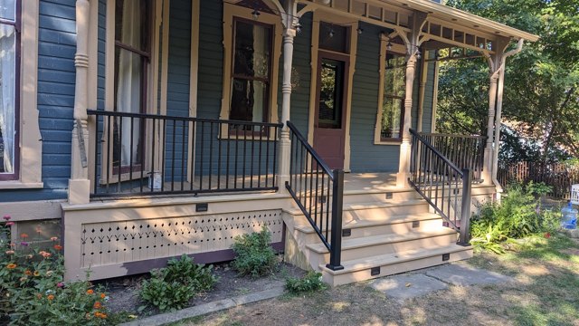 Timber porch details and dark handrails at the front entrance.