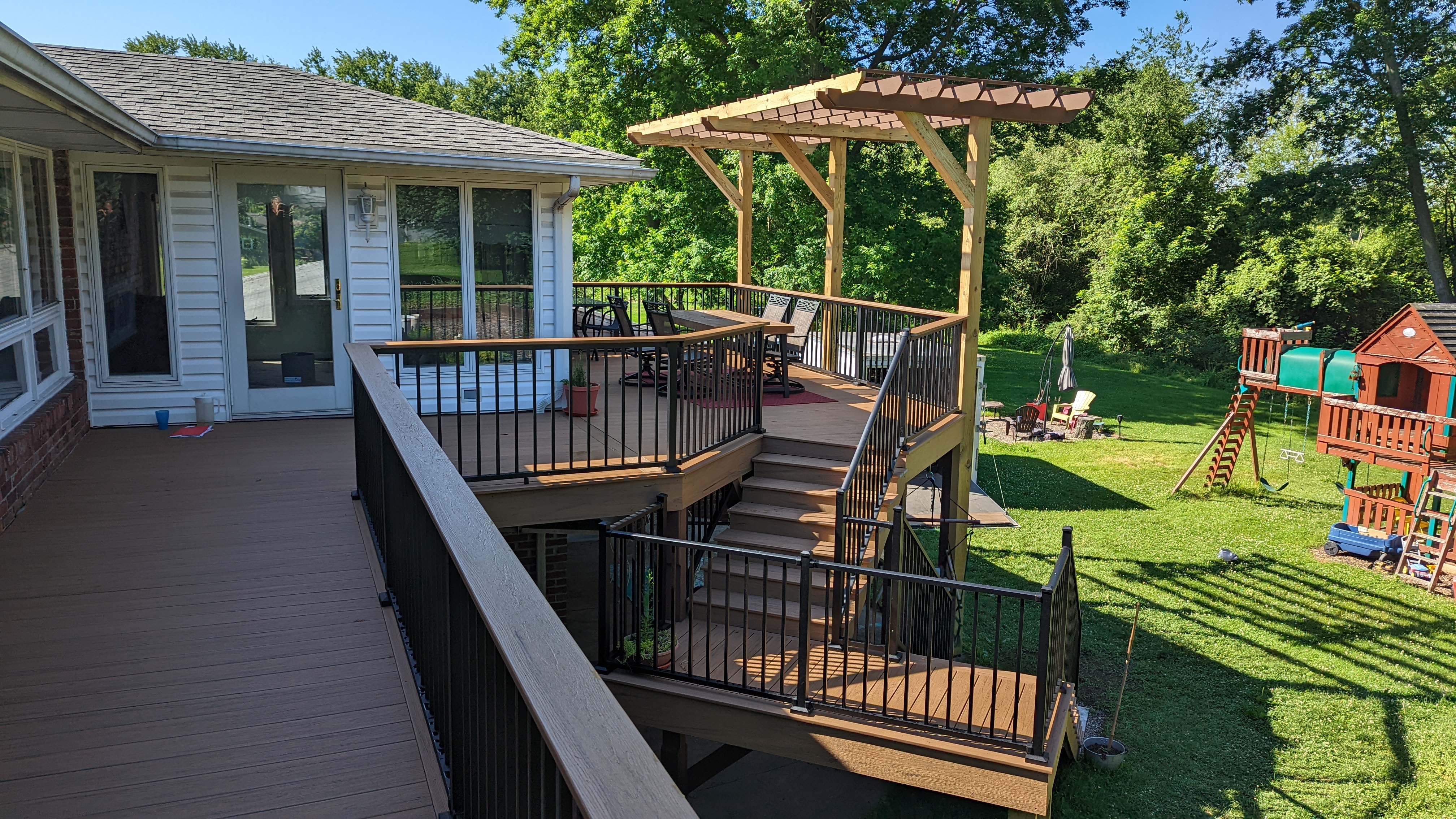 Wilton Decks project with a pergola, connected deck levels and dark railings